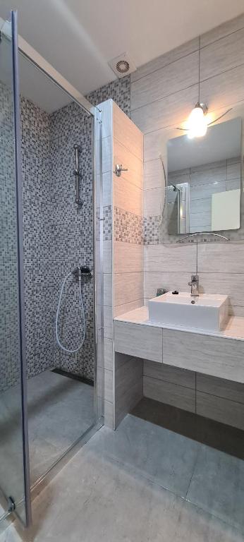 a bathroom with a sink and a shower at Apartments Ana i Ante Punta in Milna