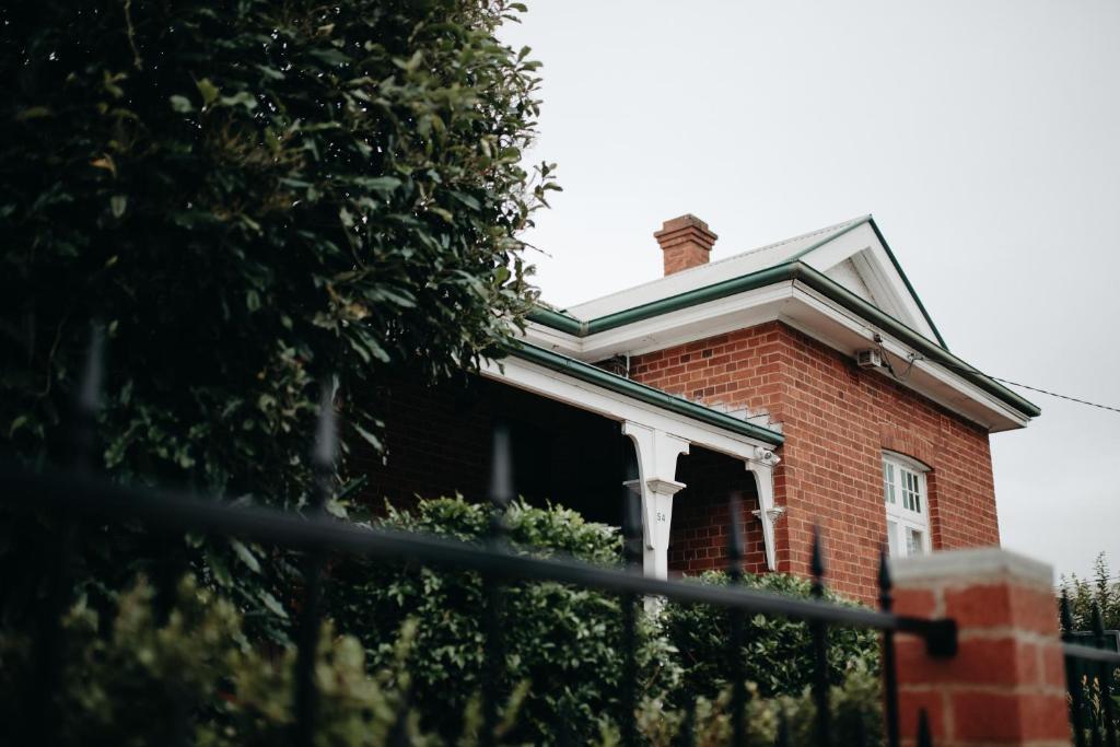 a brick house with a chimney on top of it at The Pioneer - A Luxurious, Federation Home. in Dubbo