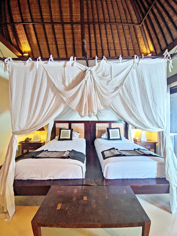 Postel nebo postele na pokoji v ubytování Barong Resort Ubud by Puri Signatures