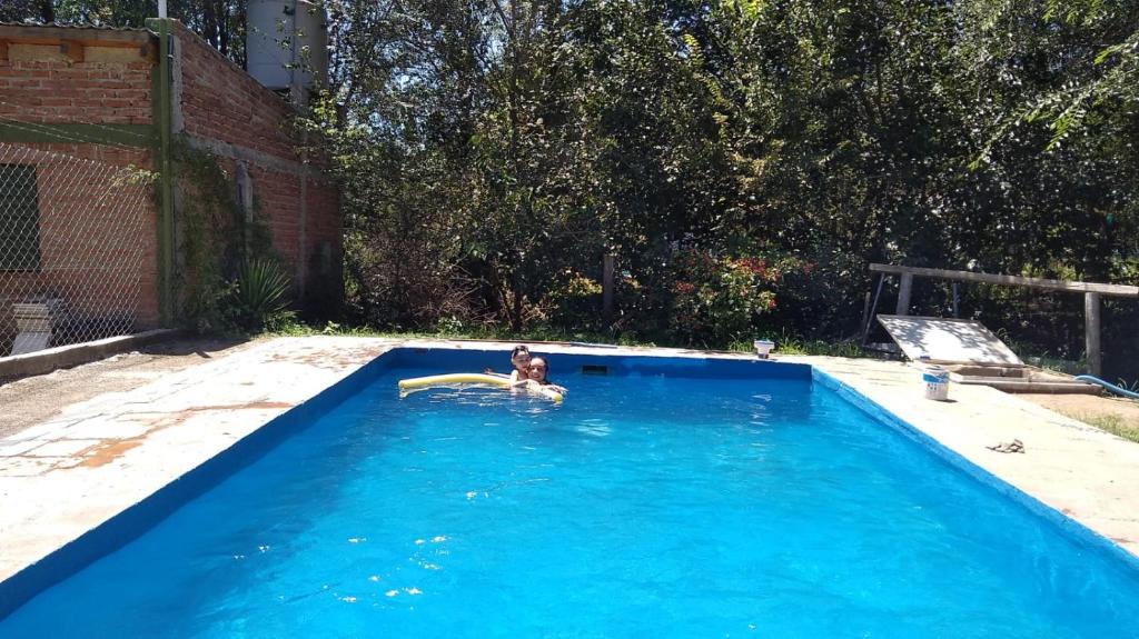 a boy in a swimming pool with a frisbee at Don Castro Alojamiento Serrano in San Roque