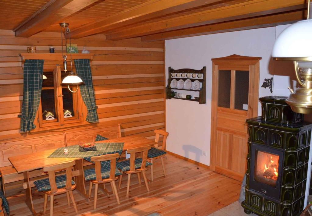 a dining room with a woodburning stove in a cabin at Holiday home in Jilove u Drzkova 1767 in Jílové u Držkova