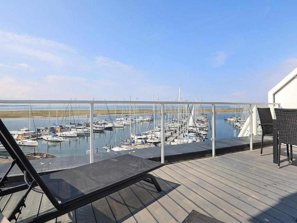 a deck with a view of a marina with boats at Apartment Wendtorf XXIX in Wendtorf