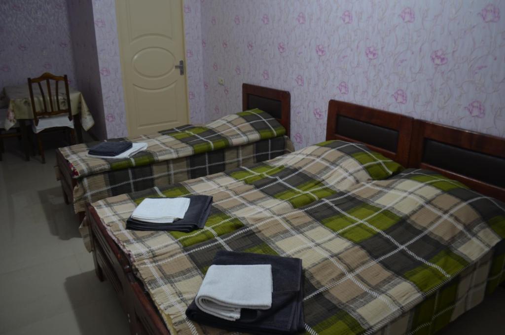 Postel nebo postele na pokoji v ubytování Alex's Cosy Guesthouse