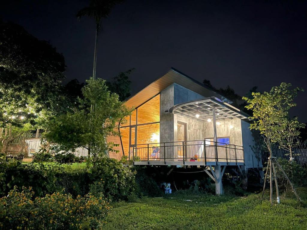 a house with a glass facade at night at The Kefi House - Bungalow Hoa Đào in Hanoi