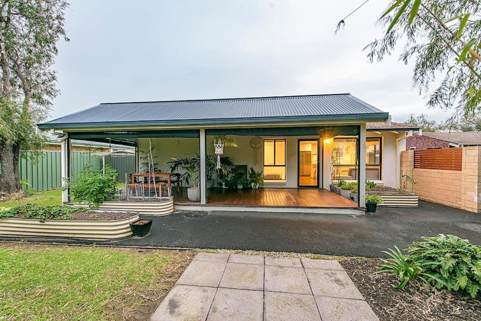 a home with a large porch and a house at Salty in Quindalup