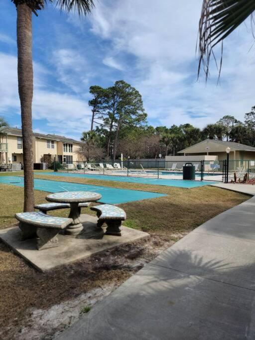 a picnic table in front of a swimming pool at 188WSD in Panama City Beach