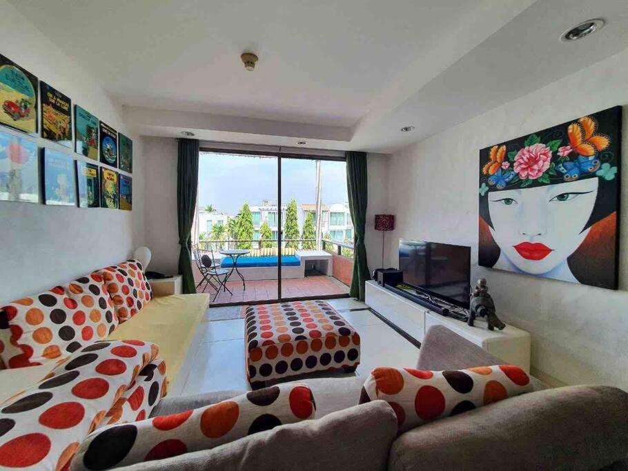 a living room with two couches and a television at Las Tortugas, Cozy condominium on Khao Tao beach, Hua Hin in Khao Tao