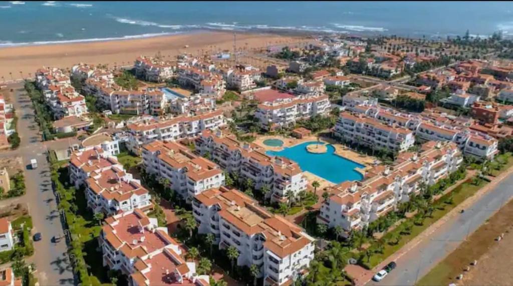 an aerial view of a resort on the beach at Bel appartement estival 2 chambres à Garden beach in Sidi Rahal