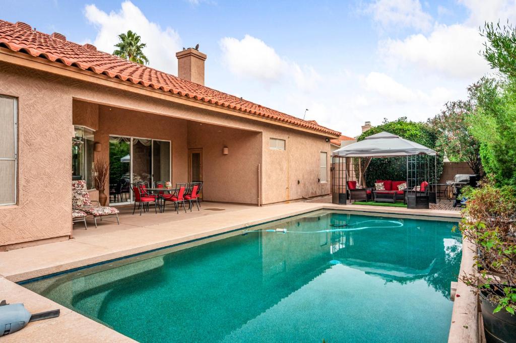 a swimming pool in front of a house at Cozy Casita in Scottsdale