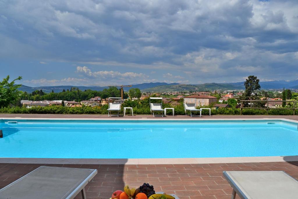 a swimming pool with a view of a city at Villa Faccioli Deodara With Shared Pool in Colognola ai Colli