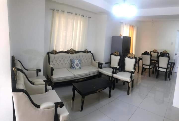 a living room with a couch and chairs and a table at Danarose residences rental in Bacoor