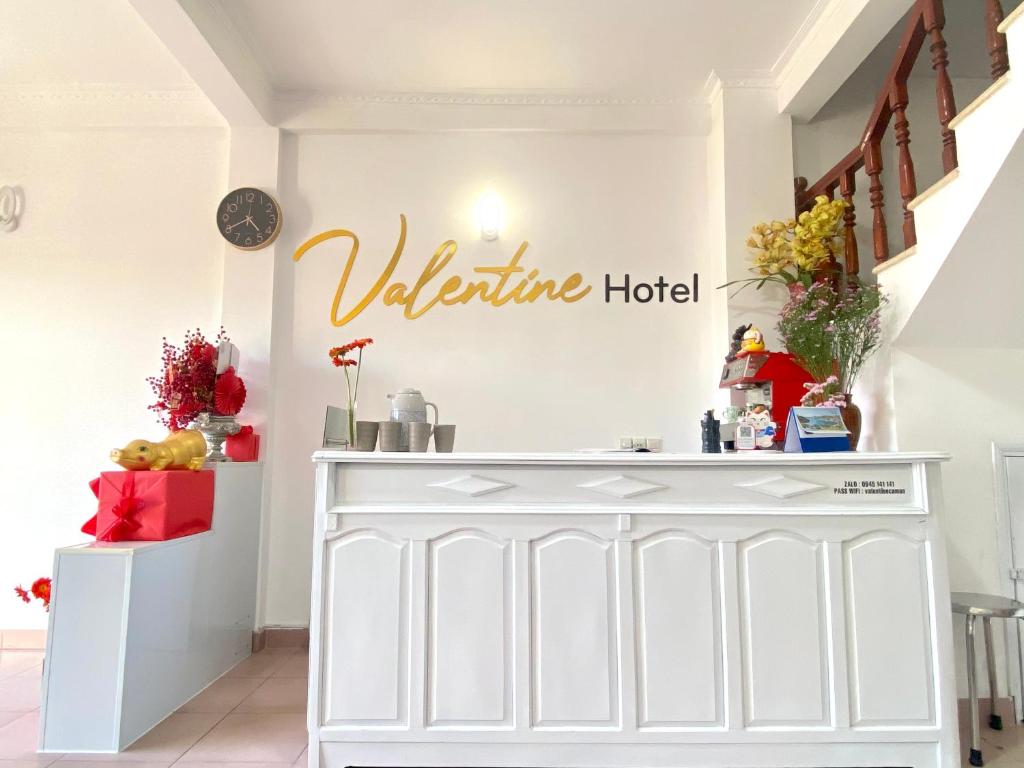 a white room with a welcome hotel sign on the wall at VALENTINE Hotel in Da Lat