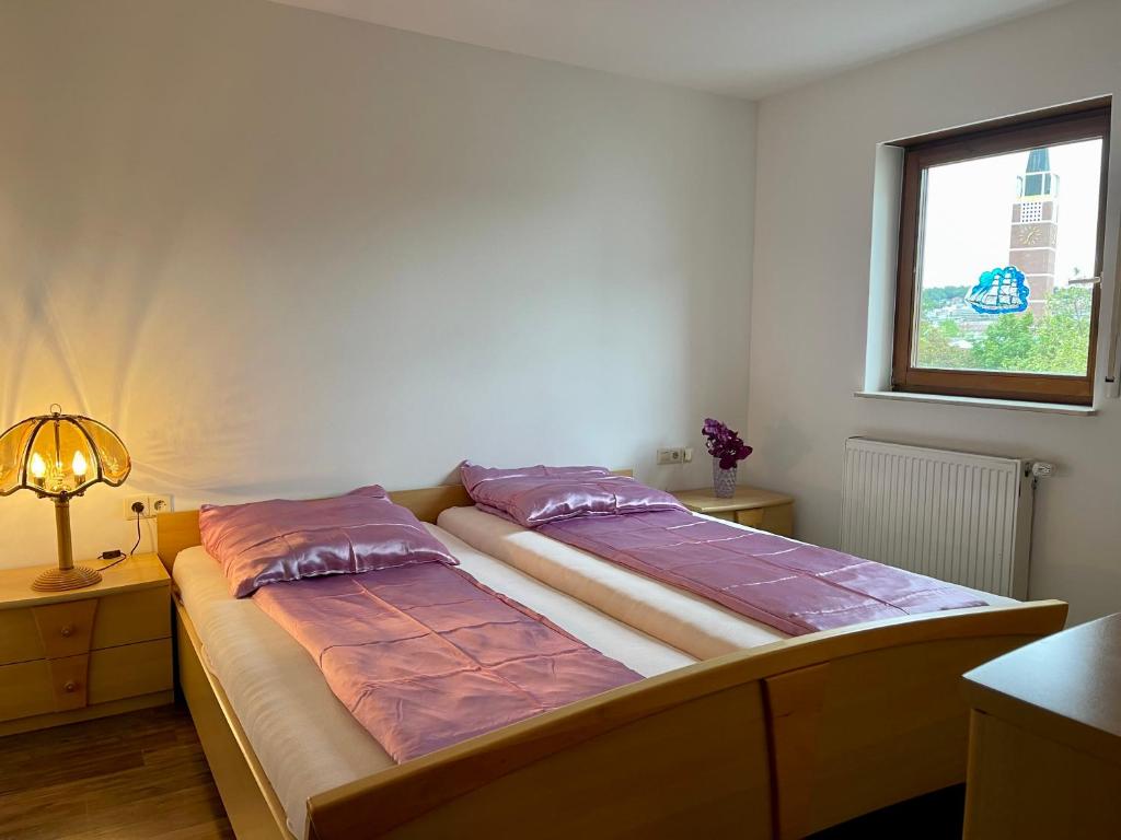 a bed with two pillows on it in a room at Wunderschönes Apartment in der Goldstadt Pforzheim in Pforzheim