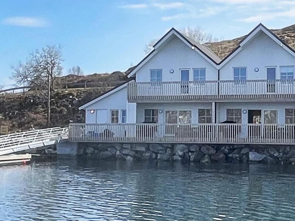 ein Haus auf einer Brücke über das Wasser in der Unterkunft 6 person holiday home in Dyrvik in Dyrvik