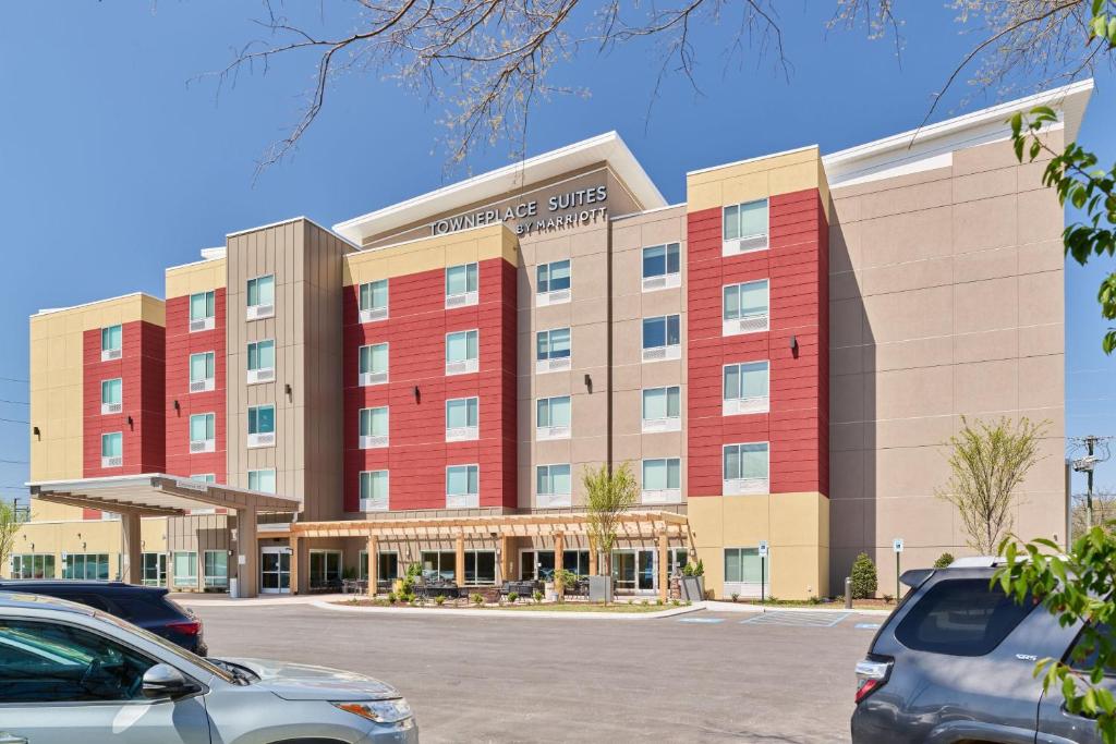 a hotel building with cars parked in a parking lot at TownePlace Suites by Marriott Hixson in Hixson