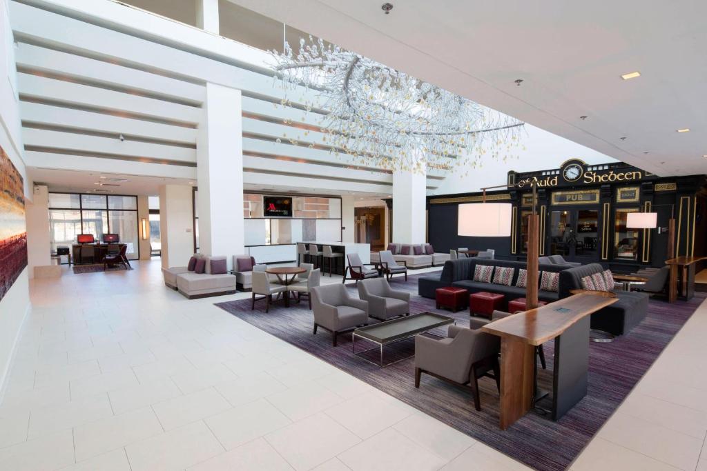 a lobby of a hotel with couches and chairs at Hanover Marriott in Whippany