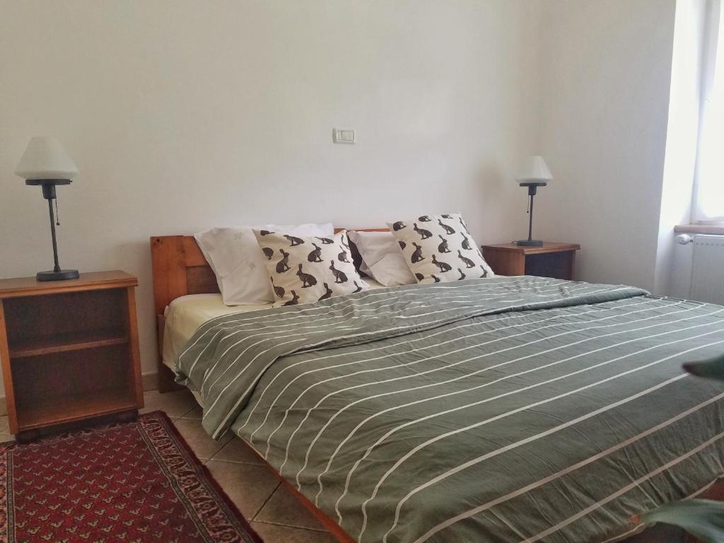 a bedroom with a bed with two night stands and two lamps at Apartma Raft, Bovec in Bovec