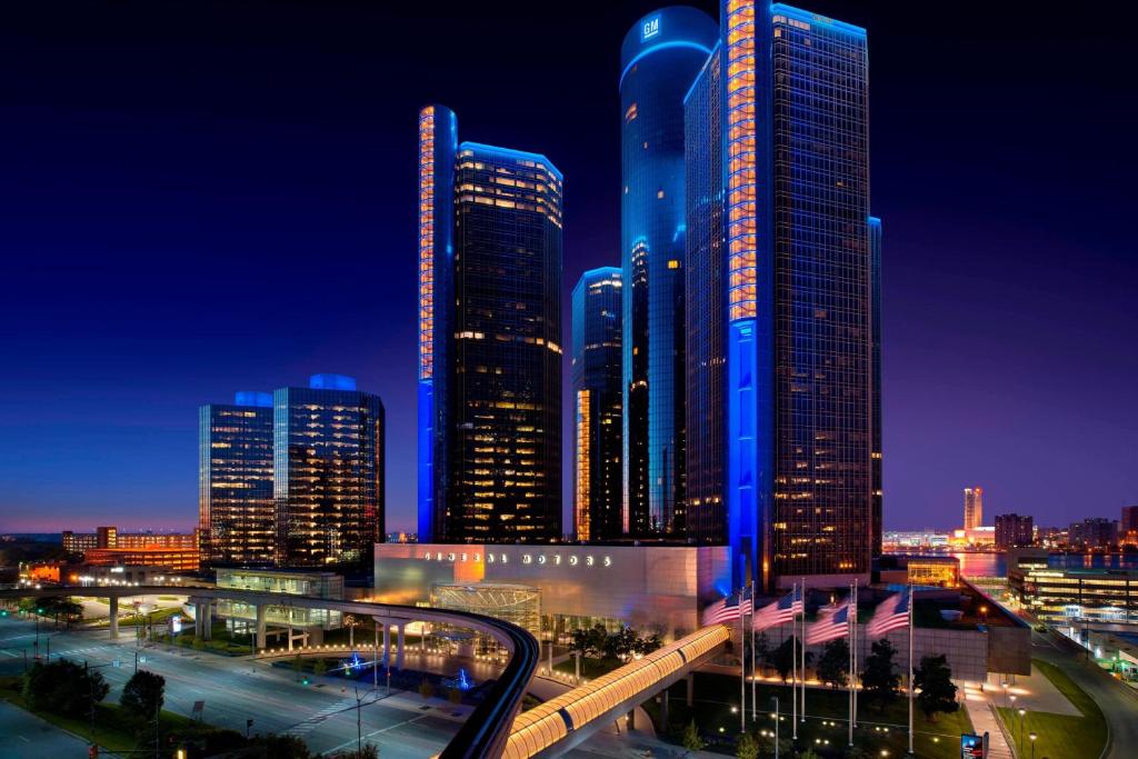 a city skyline with tall skyscrapers at night at Detroit Marriott at the Renaissance Center in Detroit