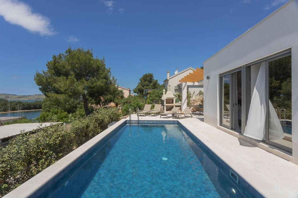 a swimming pool in the backyard of a house at Sullago in Šibenik