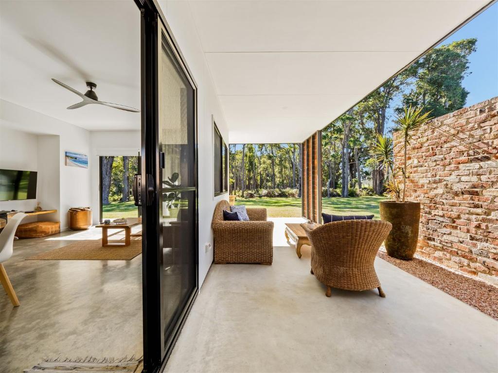 an open living room with a stone wall at Simala Retreat in Cowaramup