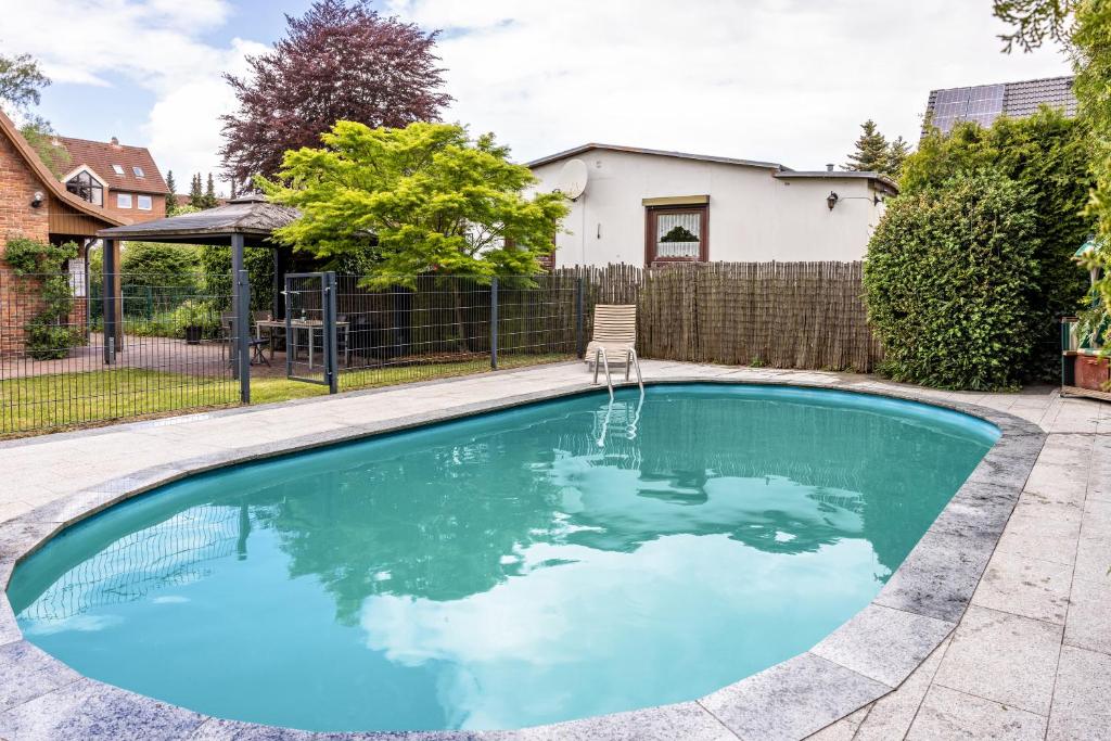 a swimming pool in the backyard of a home at Ferienhaus Baumann in Quickborn