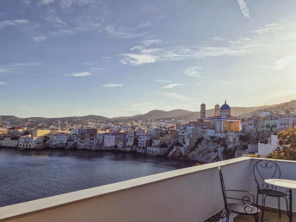 a view of a city from a balcony at Pafsilipon Suites in Ermoupoli