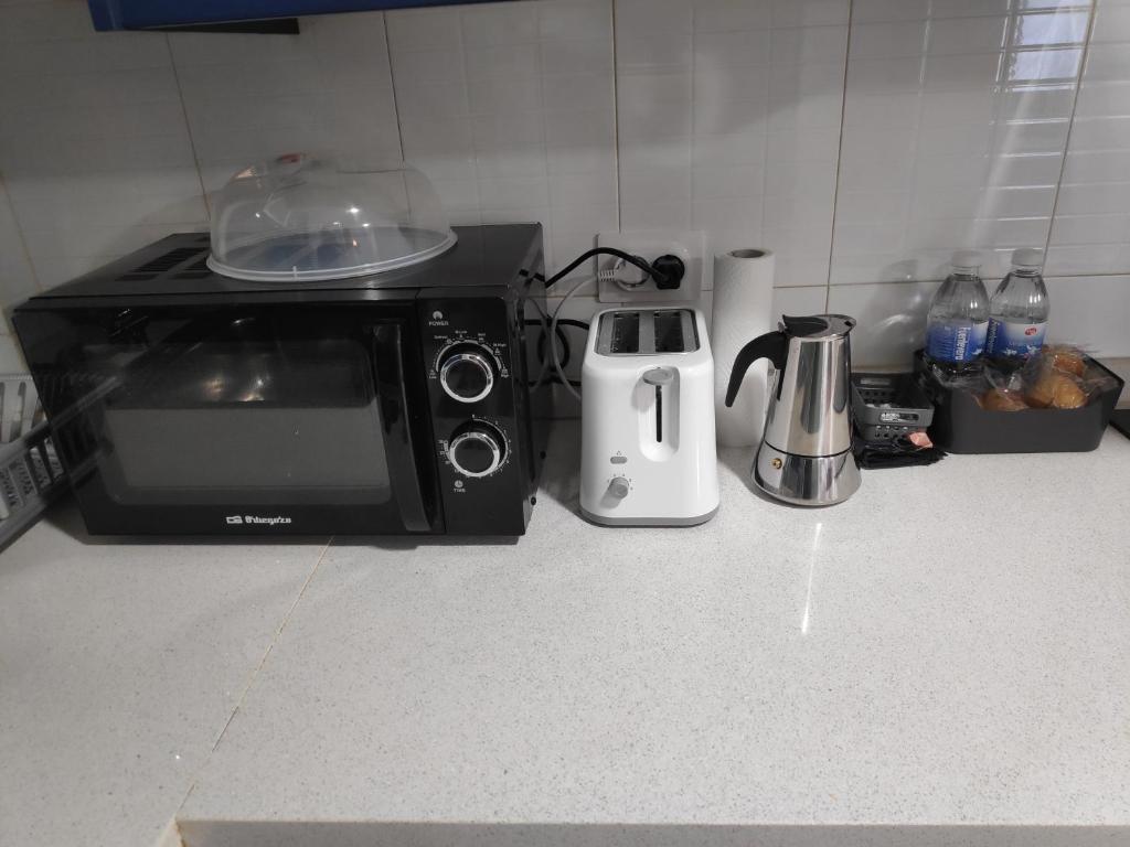 a kitchen counter with a microwave and a toaster at Estudio Francés, Parking privado gratuito in Logroño