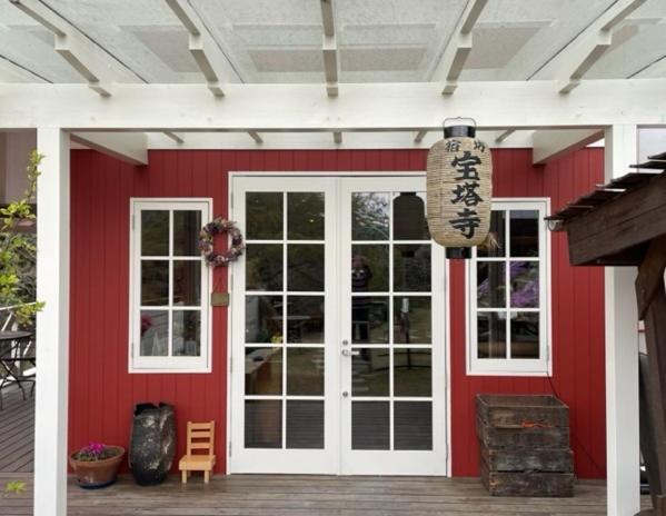 a red house with a white door and windows at Houtouji Temple in Yoshino