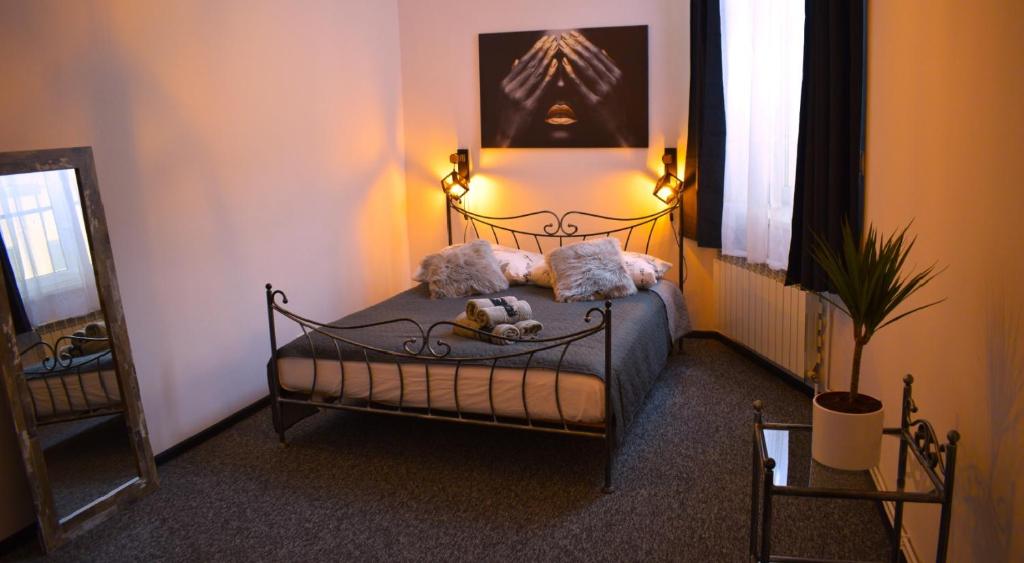 a bedroom with a bed with two stuffed animals on it at Apartamenty Rynek X in Przemyśl