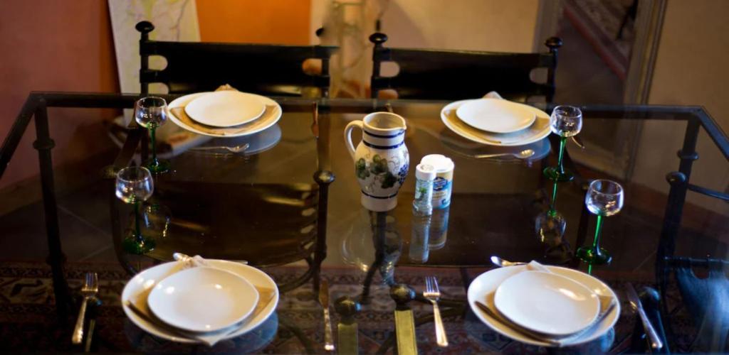 a table with plates and wine glasses on it at Lodjadis in Labaroche