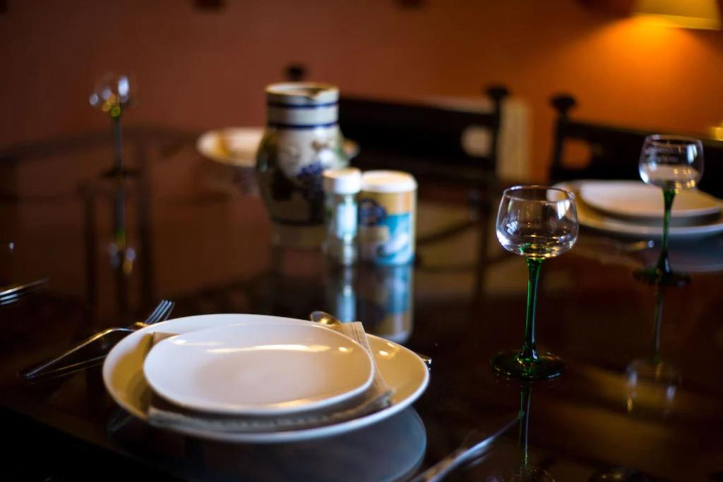 a table with plates and wine glasses on it at Lodjadis in Labaroche