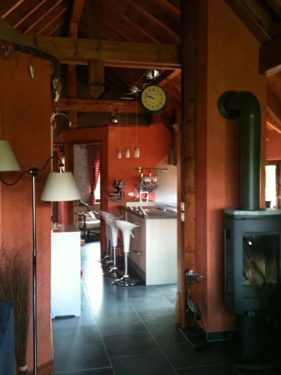 a kitchen with a stove and a clock on the wall at Lodjadis in Labaroche