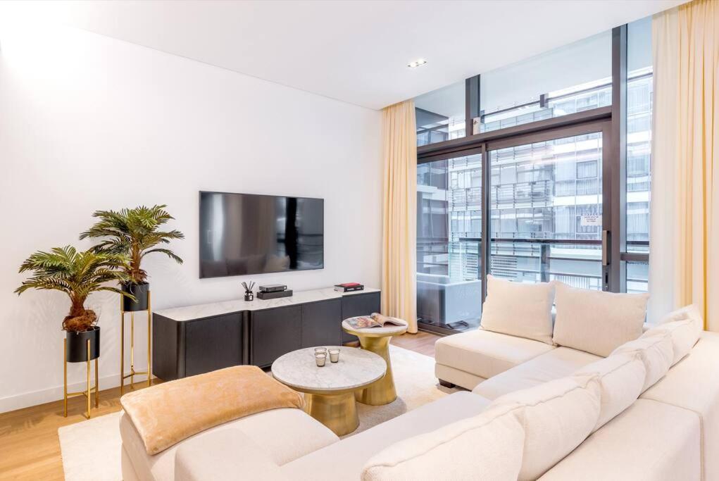a living room with a white couch and a tv at NEW! Luxurious 3 bedroom apartment in City Walk in Dubai