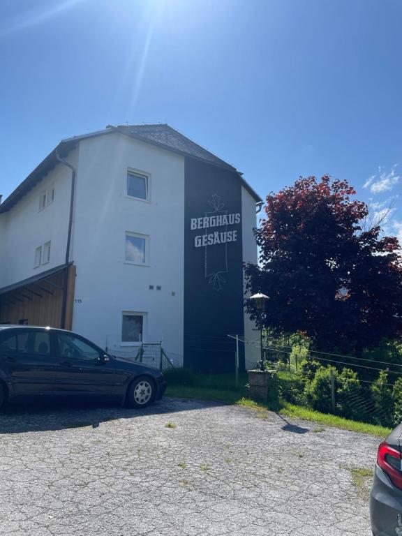 un edificio con un coche aparcado delante de él en Berghaus Gesäuse en Weng im Gesäuse