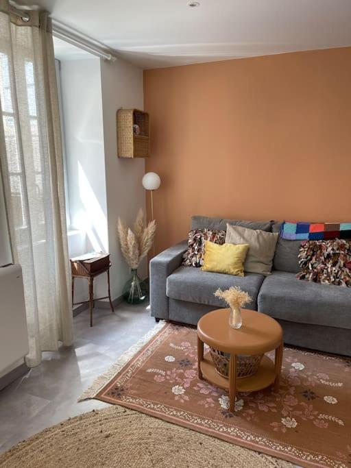 - un salon avec un canapé bleu et une table dans l'établissement Le cocon des ducs, appartement centre historique, à Nevers