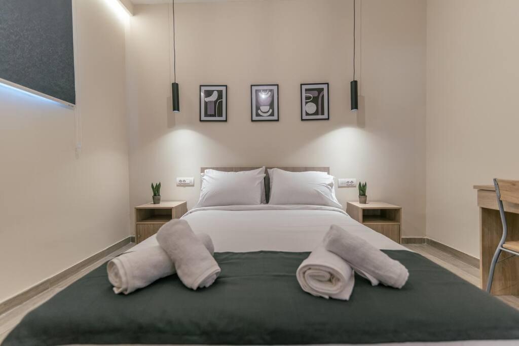 a bedroom with a large bed with towels on it at Aurora apartments Room 1 in Marmari