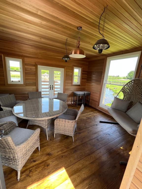 a living room with a table and chairs at East Learmouth Lakeside Lodges - Larch Lodge in Cornhill-on-tweed