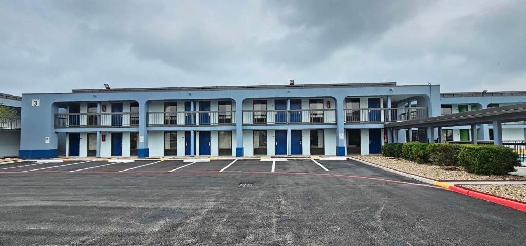 an empty parking lot in front of a building at SureStay Studio by Best Western Victoria in Victoria