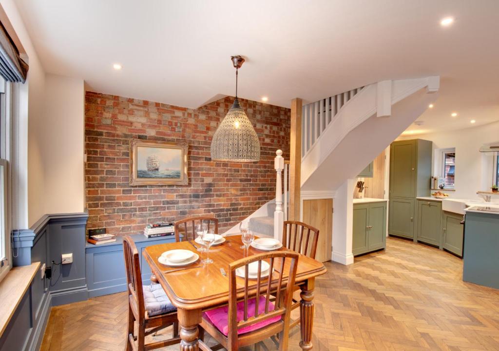 a kitchen and dining room with a table and chairs at Zeppelin in Woodbridge