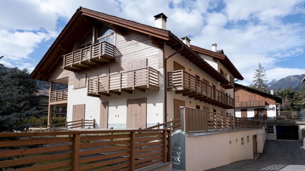 a house with wooden balconies on the side of it at Italianway - Milano 26 in Bormio