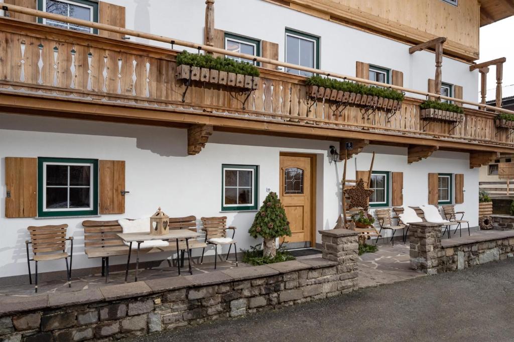 een gebouw met een tafel en stoelen en een balkon bij Appartement Am Hof Untertann in Kirchberg in Tirol