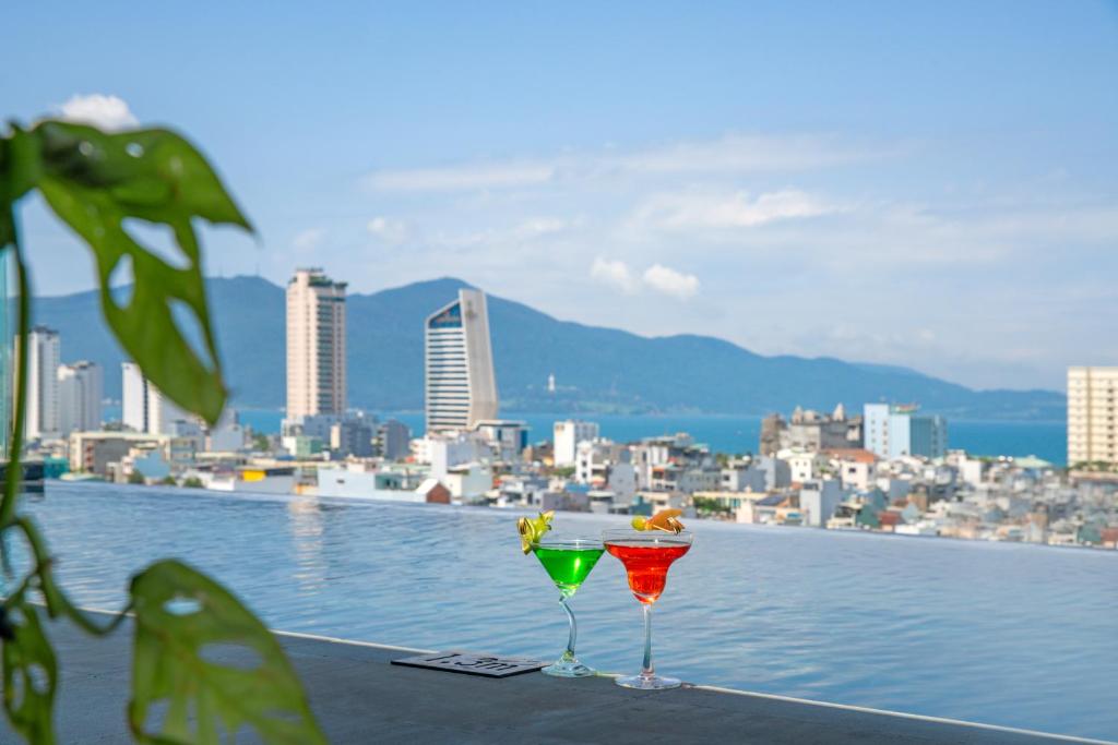 An infinity-style rooftop pool overlooking Danang’s skyline and mountains.