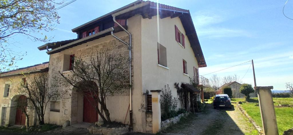 a building with a car parked next to it at Maison au calme in Viry