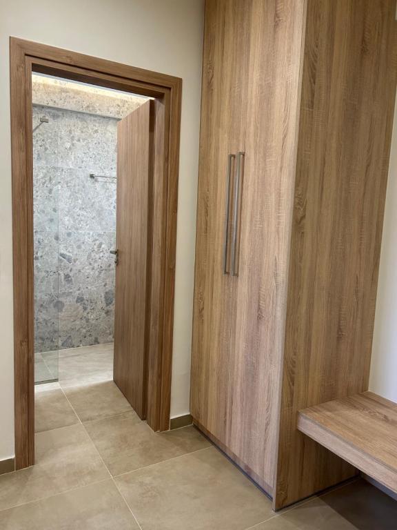a room with a wooden door and a window at Georges Estates Hotel in Stoupa