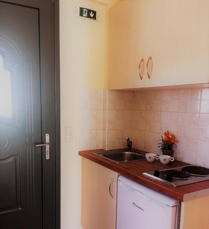 a kitchen with a sink and a counter top at Georges Estates Hotel in Stoupa
