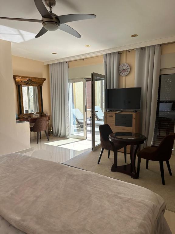 a bedroom with a bed and a television and a table at Apartments Villa Isabella in Opatija