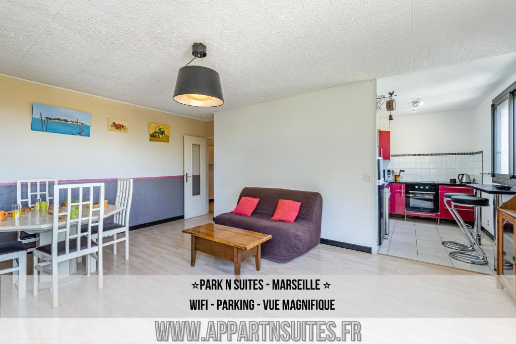 a living room with a couch and a table at Park & Suites -wifi-Netflix-vue in Marseille
