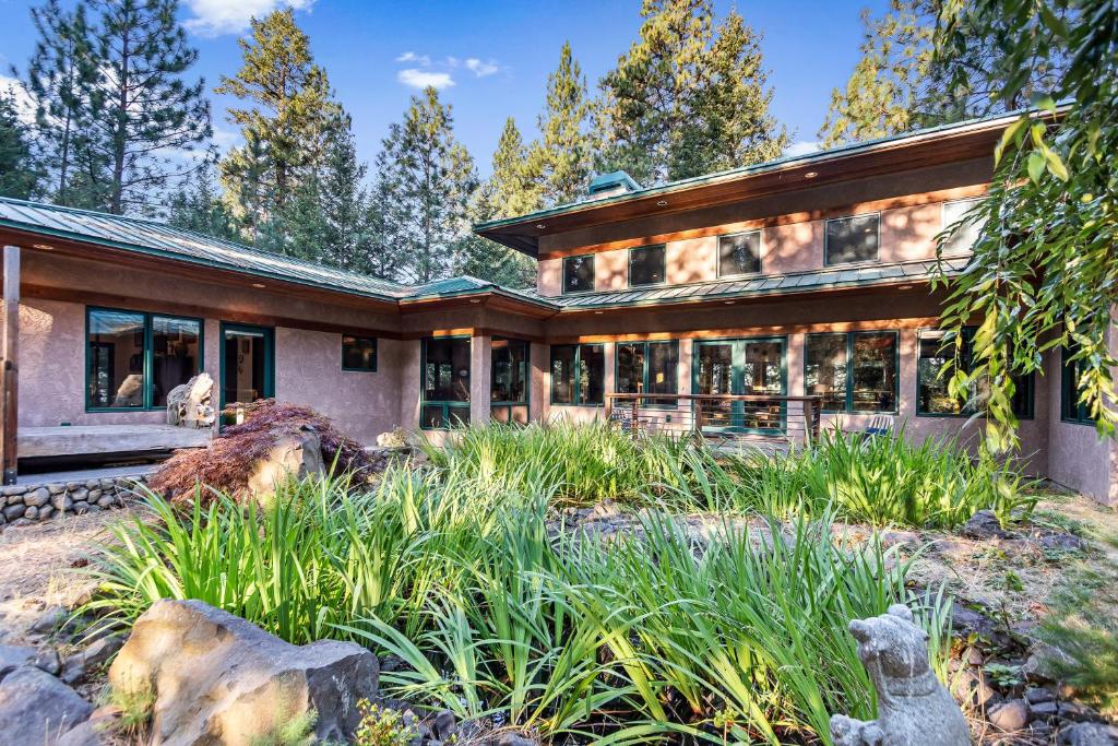 a house in the woods with a lot of windows at Selby Knoll Estate Main House and Guesthouse in Harrison