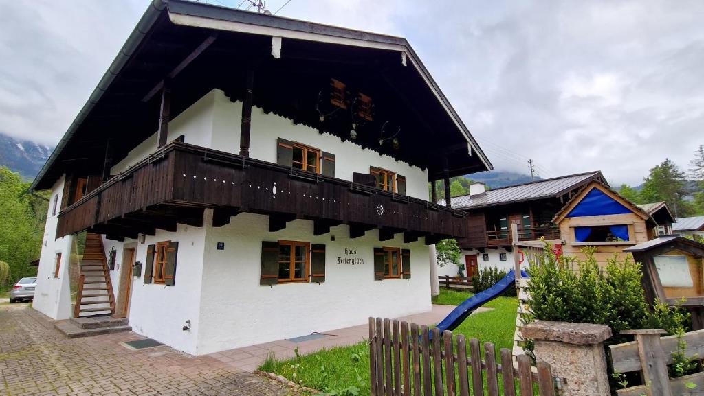 een groot wit gebouw met een zwart dak bij Apartment Huber, Schönau am Königsee in Schönau am Königssee