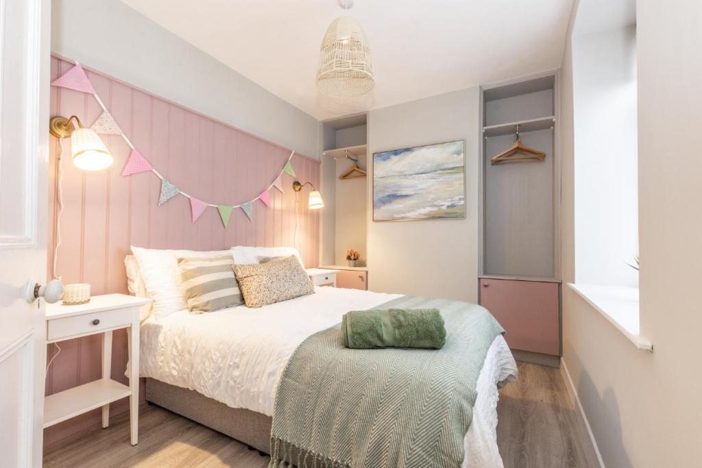 a small bedroom with a bed and a window at Historic Hideaway Waterford City in Waterford